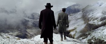 Movie still from “Blackthorn” (2011), directed by Mateo Gil – Two men are walking up a snowy hill; Wide shot, Low angle
