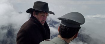 Movie still from “Blackthorn” (2011), directed by Mateo Gil – A man in a hat talking to another man in a hat; Close Up shot, Over the shoulder angle