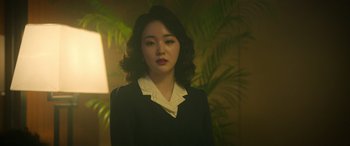A woman in a black dress and a white collar