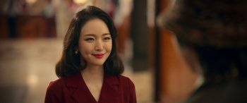 A woman in a red dress smiling for the camera