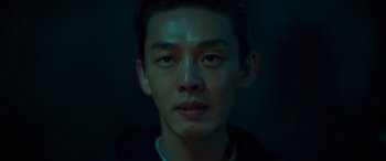 Movie still from “Seoul Vibe” (2022), directed by Hyun-Sung Moon – A man's face in the dark; Close Up shot, High angle