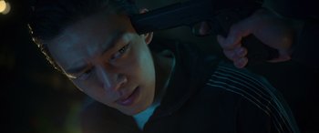 A man holding a gun up to his head