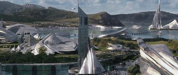 Movie still from “Serenity” (2005), directed by Joss Whedon – An aerial view of a futuristic city with a lake and mountains in the background; Extreme Wide shot, High angle
