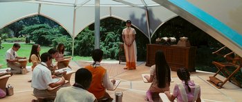 Movie still from “Serenity” (2005), directed by Joss Whedon – A woman standing in front of a group of people; Wide shot, High angle