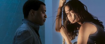 Movie still from “Serenity” (2005), directed by Joss Whedon – A man and a woman standing next to each other; Medium shot, Low angle