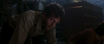 Movie still from “Serenity” (2005), directed by Joss Whedon – A person in a room near a table; Close Up shot, Over the shoulder angle