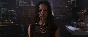 Movie still from “Serenity” (2005), directed by Joss Whedon – A woman with long dark hair wearing a black dress; Close Up shot, Low angle