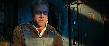 Movie still from “Serenity” (2005), directed by Joss Whedon – A young man in a jacket is looking at the camera; Close Up shot, Over the shoulder angle