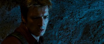 Movie still from “Serenity” (2005), directed by Joss Whedon – A man's face in front of a wall; Close Up shot, Low angle