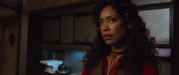 Movie still from “Serenity” (2005), directed by Joss Whedon – A person with curly hair in a room; Close Up shot, Low angle