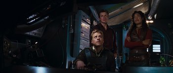 Movie still from “Serenity” (2005), directed by Joss Whedon – Two men standing next to each other in a room; Medium shot, Low angle