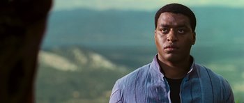 Movie still from “Serenity” (2005), directed by Joss Whedon – A person wearing a blue shirt; Close Up shot, Low angle