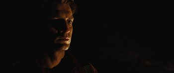 Movie still from “Serenity” (2005), directed by Joss Whedon – A person in a dark room; Close Up shot, Low angle