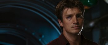 Movie still from “Serenity” (2005), directed by Joss Whedon – A person wearing a red shirt; Close Up shot, Over the shoulder angle