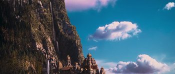 Movie still from “Serenity” (2005), directed by Joss Whedon – A view of a mountain with a sky filled with fluffy clouds; Extreme Wide shot, Low angle