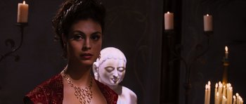 Movie still from “Serenity” (2005), directed by Joss Whedon – A woman standing in front of a statue of a buddha; Close Up shot, Over the shoulder angle