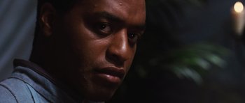 Movie still from “Serenity” (2005), directed by Joss Whedon – A man's face in the dark; Close Up shot, Low angle