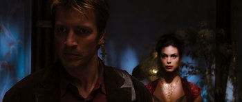 Movie still from “Serenity” (2005), directed by Joss Whedon – A man and a woman standing next to each other in the dark; Close Up shot, Over the shoulder angle