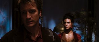 Movie still from “Serenity” (2005), directed by Joss Whedon – A man and a woman standing next to each other; Close Up shot, Over the shoulder angle
