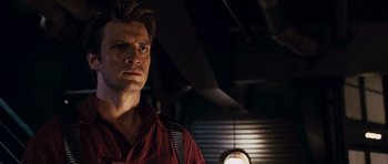 Movie still from “Serenity” (2005), directed by Joss Whedon – A man standing in a dark room looking up at the ceiling; Close Up shot, Low angle