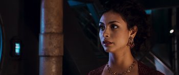 Movie still from “Serenity” (2005), directed by Joss Whedon – A person wearing a necklace; Close Up shot, Over the shoulder angle