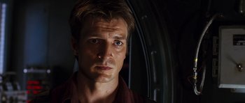 Movie still from “Serenity” (2005), directed by Joss Whedon – A person wearing a red shirt; Close Up shot, Low angle