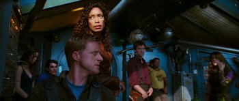 Movie still from “Serenity” (2005), directed by Joss Whedon – A group of men and women standing in a room; Medium shot, Over the shoulder angle