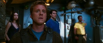 Movie still from “Serenity” (2005), directed by Joss Whedon – A man standing next to another man on a boat; Close Up shot, Over the shoulder angle