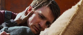 Movie still from “Serenity” (2005), directed by Joss Whedon – A person leaning on a wall; Extreme Close Up shot, Over the shoulder angle