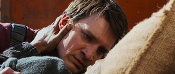 Movie still from “Serenity” (2005), directed by Joss Whedon – A person holding his ear; Close Up shot, Over the shoulder angle