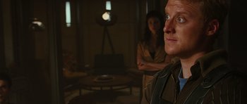 Movie still from “Serenity” (2005), directed by Joss Whedon – A man and a woman standing in front of a lamp; Close Up shot, Over the shoulder angle