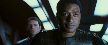 Movie still from “Serenity” (2005), directed by Joss Whedon – A man in a black shirt and a man in a white shirt; Close Up shot, Over the shoulder angle