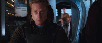 Movie still from “Serenity” (2005), directed by Joss Whedon – A person with a gun; Close Up shot, Over the shoulder angle