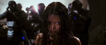 Movie still from “Serenity” (2005), directed by Joss Whedon – A woman with wet hair is looking at the camera; Close Up shot, Low angle