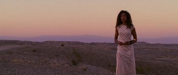 Movie still from “Serenity” (2005), directed by Joss Whedon – A woman standing in the desert at sunset; Wide shot, Low angle