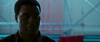 Movie still from “Serenity” (2005), directed by Joss Whedon – A man's face in front of a blurry background; Close Up shot, Over the shoulder angle