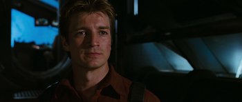 Movie still from “Serenity” (2005), directed by Joss Whedon – A person wearing a red shirt; Close Up shot, Over the shoulder angle