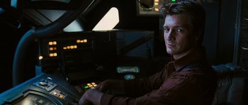 Movie still from “Serenity” (2005), directed by Joss Whedon – A man sitting in front of a computer monitor; Close Up shot, Over the shoulder angle