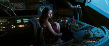 Movie still from “Serenity” (2005), directed by Joss Whedon – A woman sitting on a chair in a room; Medium shot, High angle