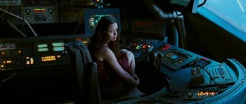 Movie still from “Serenity” (2005), directed by Joss Whedon – A woman sitting on a chair in a room; Medium shot, High angle