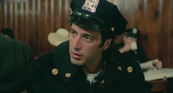 Movie still from “Serpico” (1973), directed by Sidney Lumet – A person wearing a hat; Close Up shot, Low angle