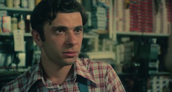 Movie still from “Serpico” (1973), directed by Sidney Lumet – A person wearing a plaid shirt; Close Up shot, Low angle