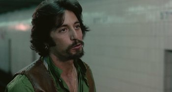 Movie still from “Serpico” (1973), directed by Sidney Lumet – A person with a beard; Close Up shot, Over the shoulder angle