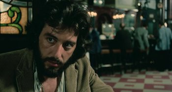 Movie still from “Serpico” (1973), directed by Sidney Lumet – A person sitting in a room; Close Up shot, Over the shoulder angle