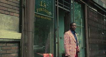 Movie still from “Serpico” (1973), directed by Sidney Lumet – A man standing in front of a store window; Medium shot, Low angle