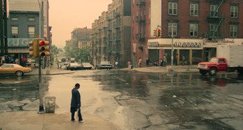 Movie still from “Serpico” (1973), directed by Sidney Lumet – A man walking on the sidewalk of a city street; Extreme Wide shot, High angle