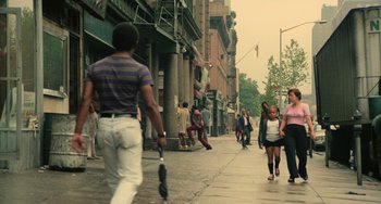 Movie still from “Serpico” (1973), directed by Sidney Lumet – A group of people walking down a sidewalk; Wide shot, Low angle