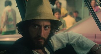 Movie still from “Serpico” (1973), directed by Sidney Lumet – A man with a beard wearing a hat; Close Up shot, Low angle
