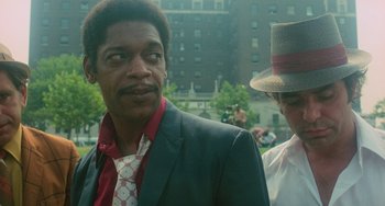 Movie still from “Serpico” (1973), directed by Sidney Lumet – A man in a suit and a woman in a hat; Close Up shot, Over the shoulder angle