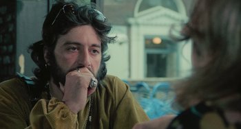 Movie still from “Serpico” (1973), directed by Sidney Lumet – A man sitting in front of a window with his hand to his face; Close Up shot, Over the shoulder angle